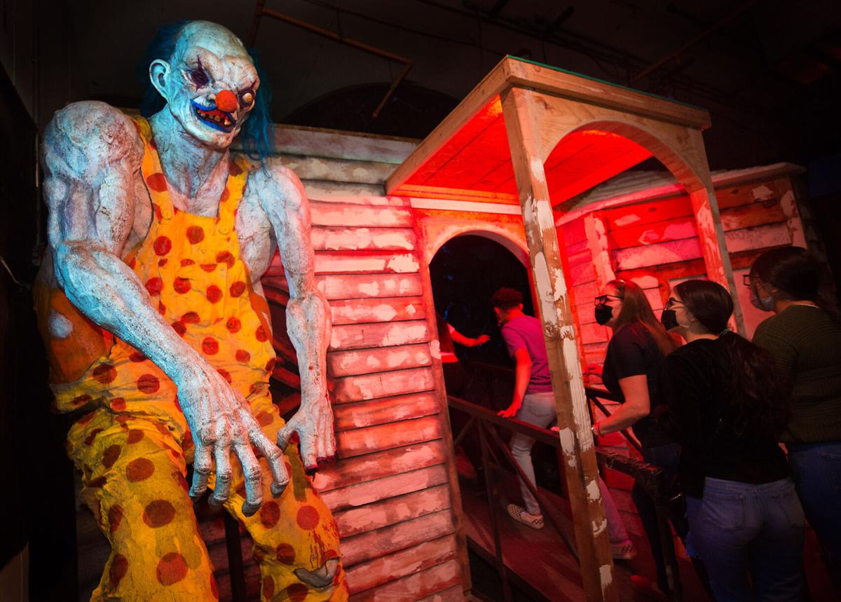 Guests walking through a dark haunted attraction at Slaughterhouse Tucson